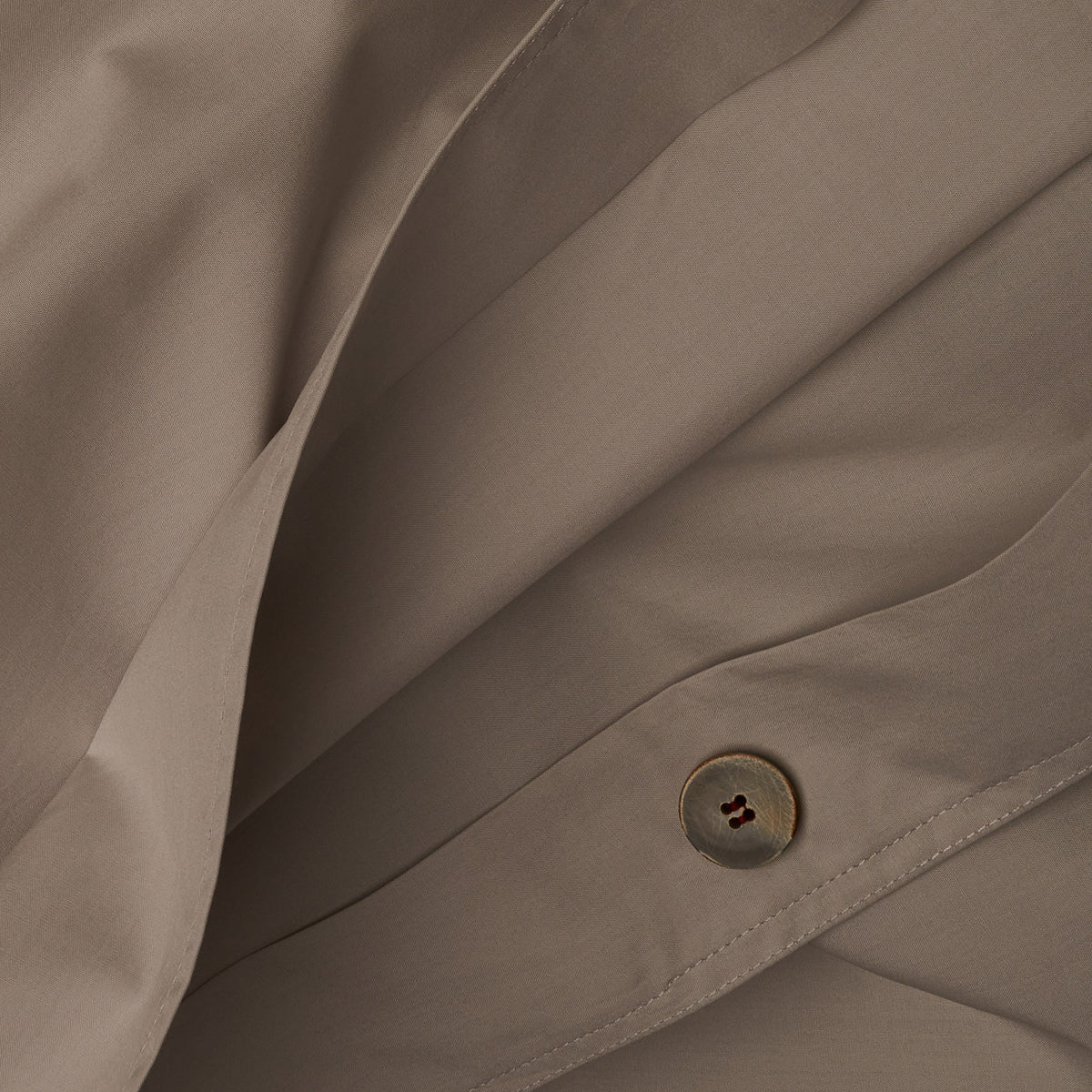 Close up image of the button closure on a LETTO Classic Cotton Percale duvet cover in color gray. data-image-id=