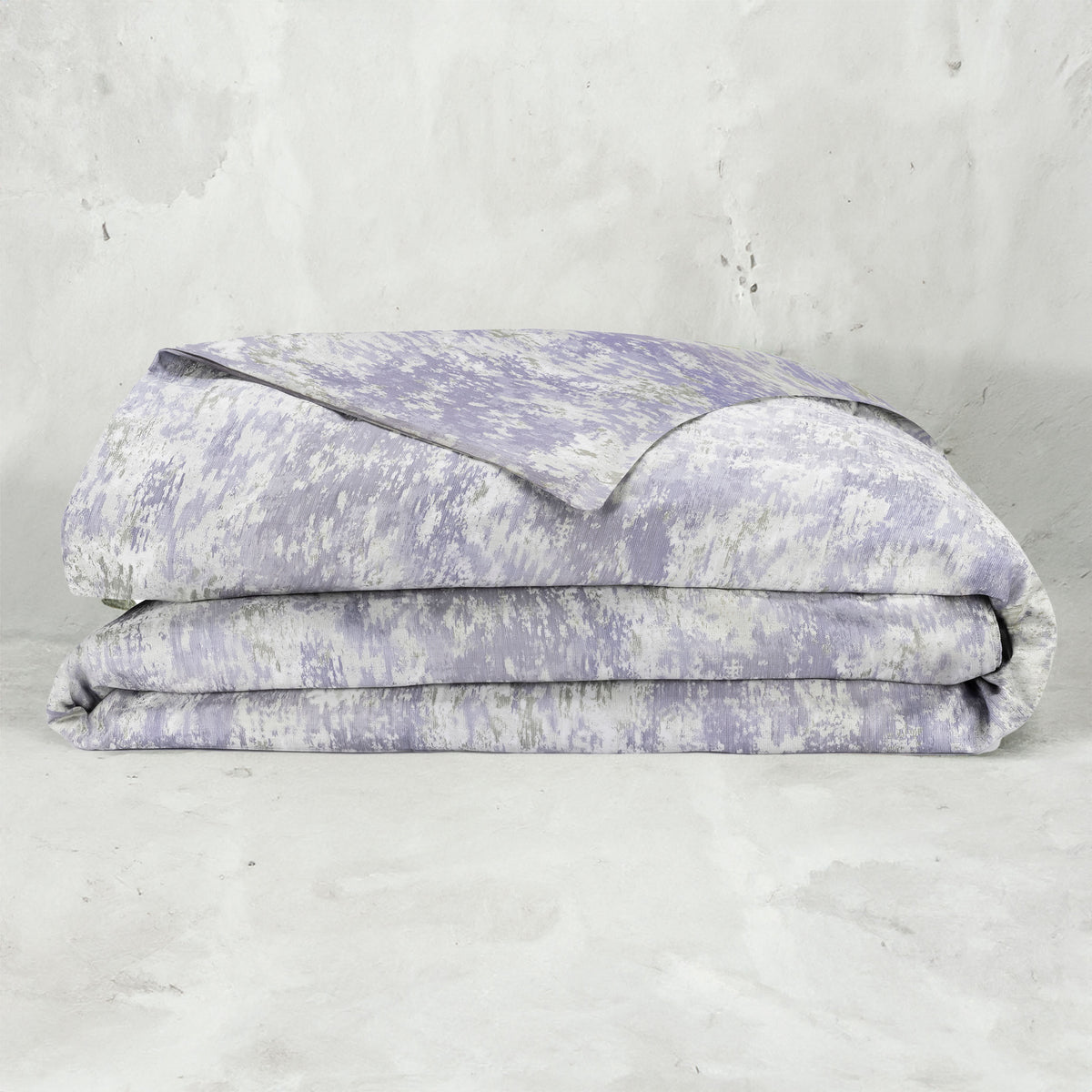A folded LETTO Le Marais Jacquard Duvet cover in color Amethyst. data-image-id=