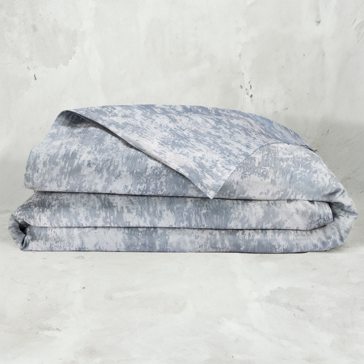 A folded LETTO Le Marais Jacquard Duvet cover in color Ocean. data-image-id=