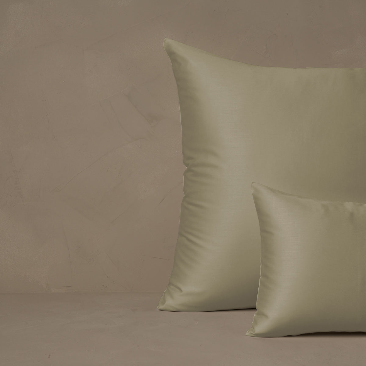 An image of a small boudoir or travel size pillow stacked in front of a large euro size pillow. The pillow cases are made in Italy of LETTO Woodland Silk fabric in color Pistachio, a smooth and silky beechwood modal. data-image-id=