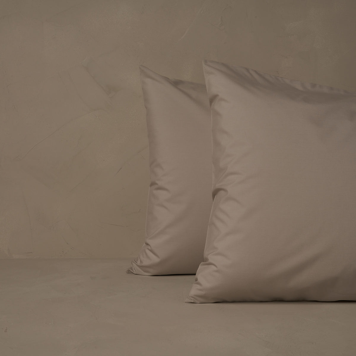 An image of two pillows stacked one in front of the other. The pillow cases are made of LETTO's cool and crisp Classic Cotton Percale in color gray. data-image-id=