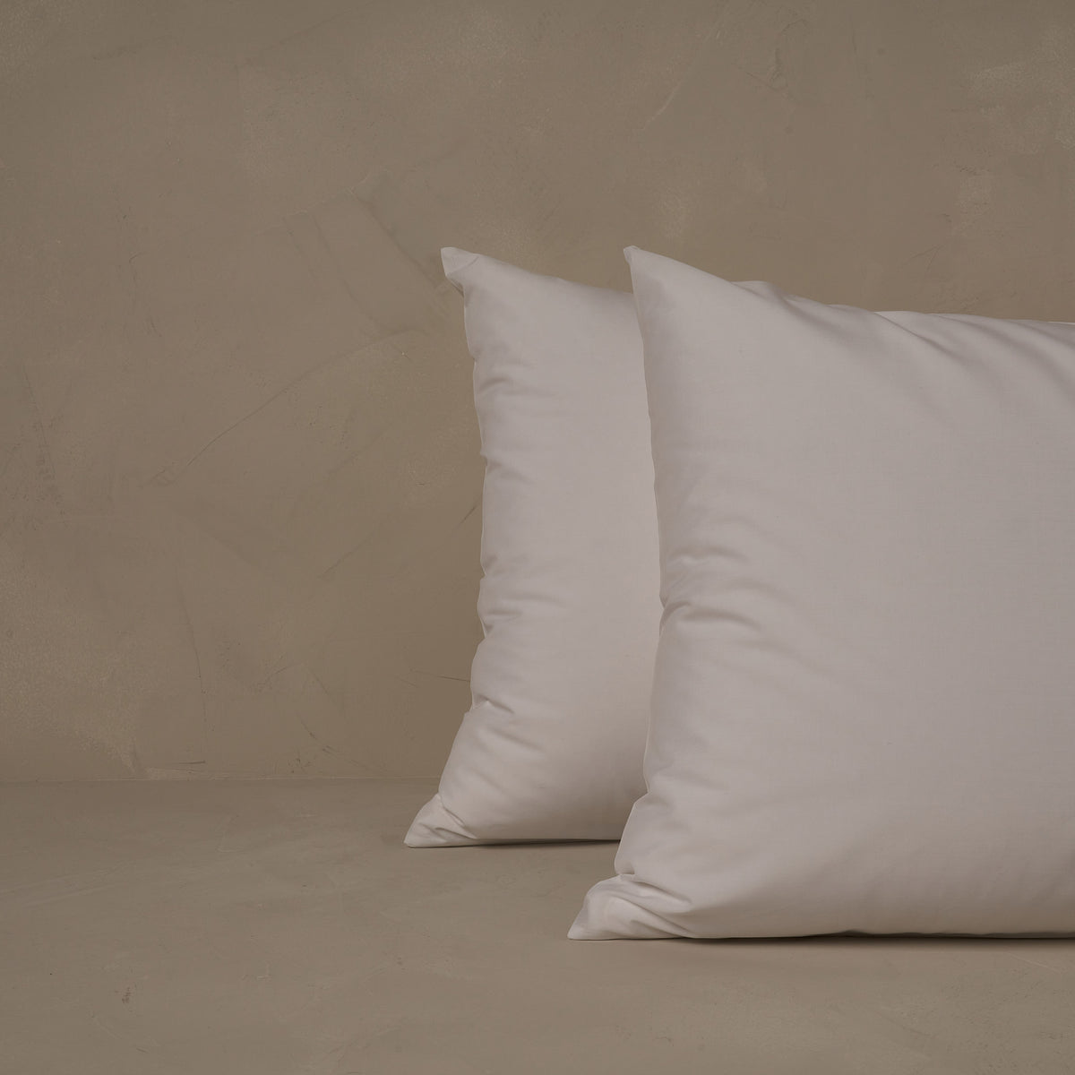 An image of two pillows stacked one in front of the other. The pillow cases are made of LETTO's cool and crisp Classic Cotton Percale in color white. data-image-id=