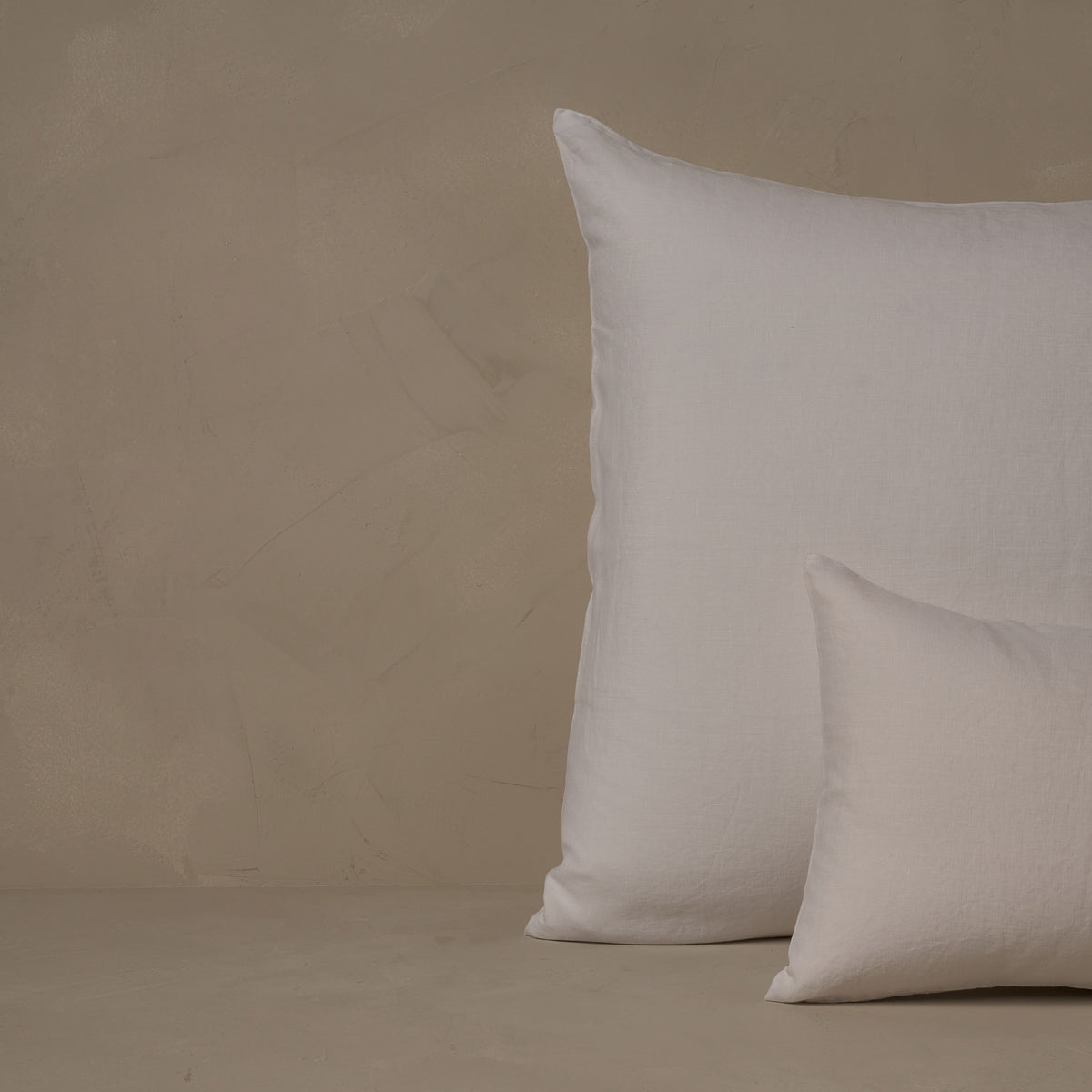 An image of a small boudoir or travel size pillow stacked in front of a large euro size pillow. The pillow cases are made in Italy of breathable and relaxed 100% linen, LETTO Classic Linen in color white. data-image-id=