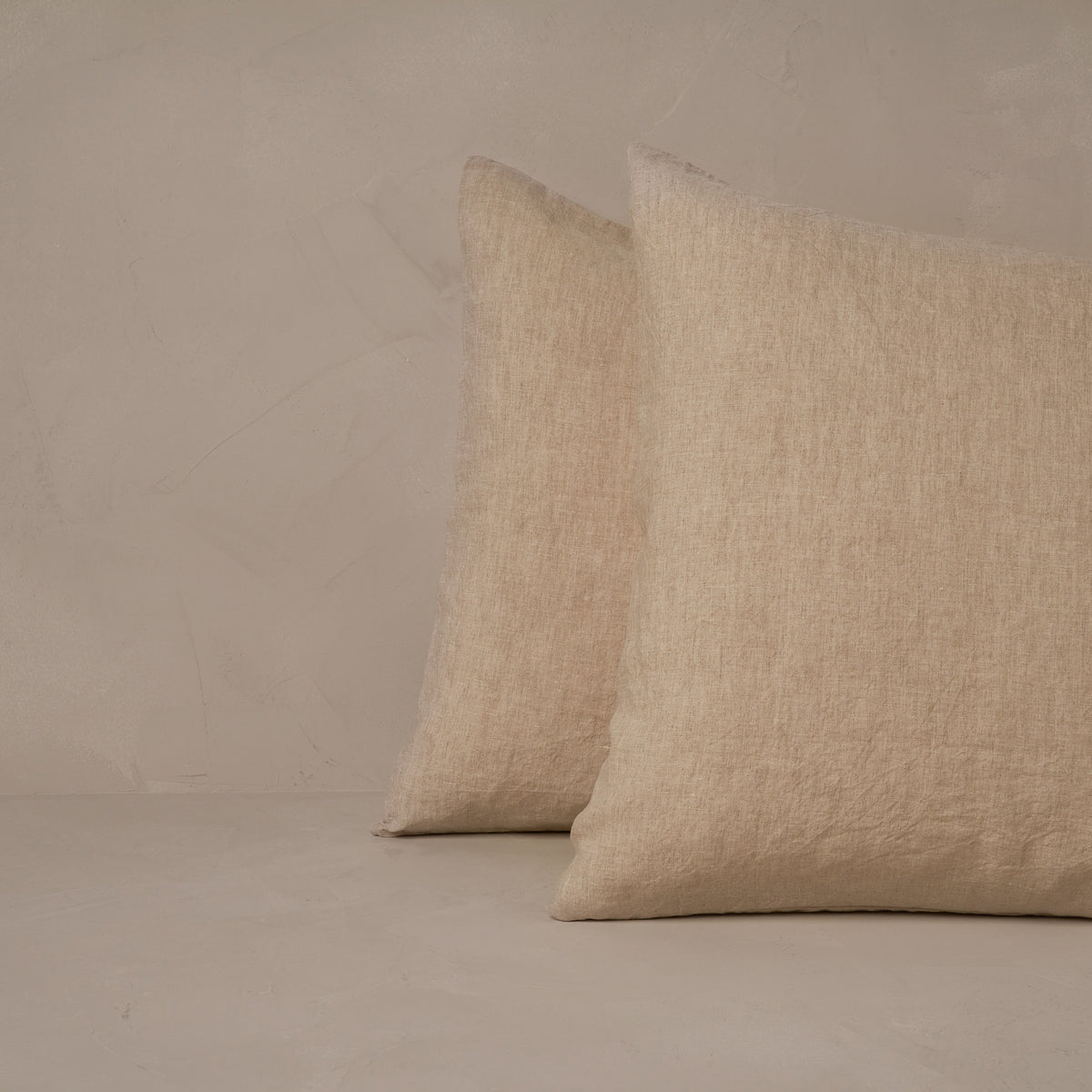 An image of two pillows stacked one in front of the other. The pillow cases are made of LETTO Classic Linen in color natural. data-image-id=