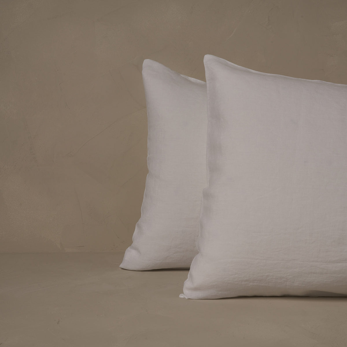 An image of two pillows stacked one in front of the other. The pillow cases are made of LETTO Classic Linen in color white. data-image-id=