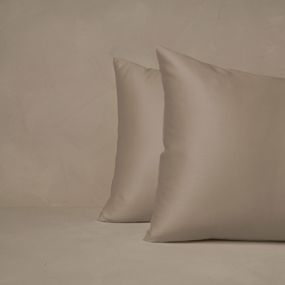 An image of two pillows stacked one in front of the other. The pillow cases are made of LETTO Woodland Silk beechwood modal in color candlelight. data-image-id=