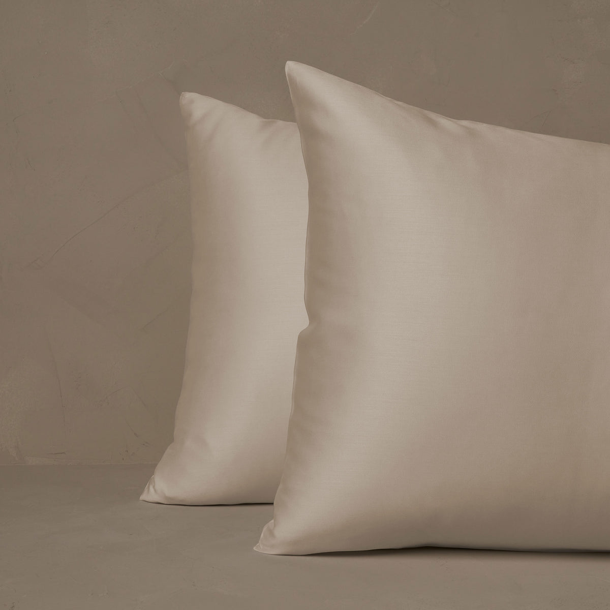 An image of two pillows stacked one in front of the other. The pillow cases are made of LETTO Woodland Silk beechwood modal in color ivory. data-image-id=