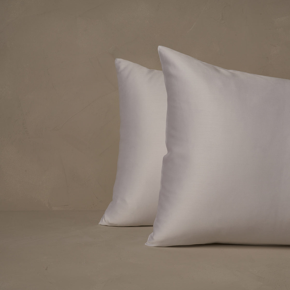 An image of two pillows stacked one in front of the other. The pillow cases are made of LETTO Woodland Silk beechwood modal in color white. data-image-id=