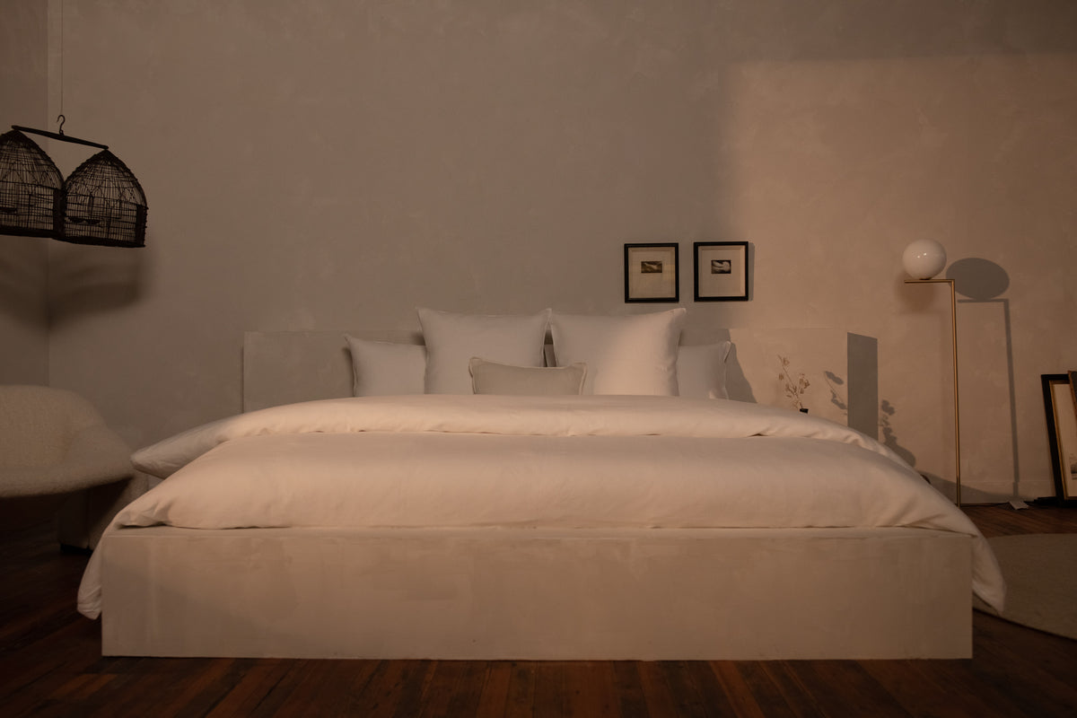 A large king size bed made in white Sea Island Cotton Sateen sheets and duvet cover. data-image-id=