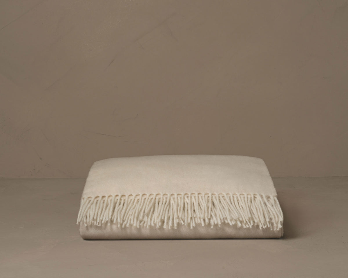 Color cream pure cashmere throw with an accented fringe trim. Made in Italy.  data-image-id=