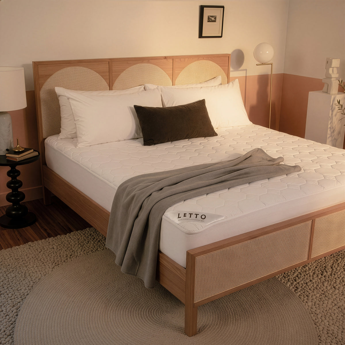Bedroom with a wooden bed frame and white bedding, featuring the brand 'Letto'. data-image-id=