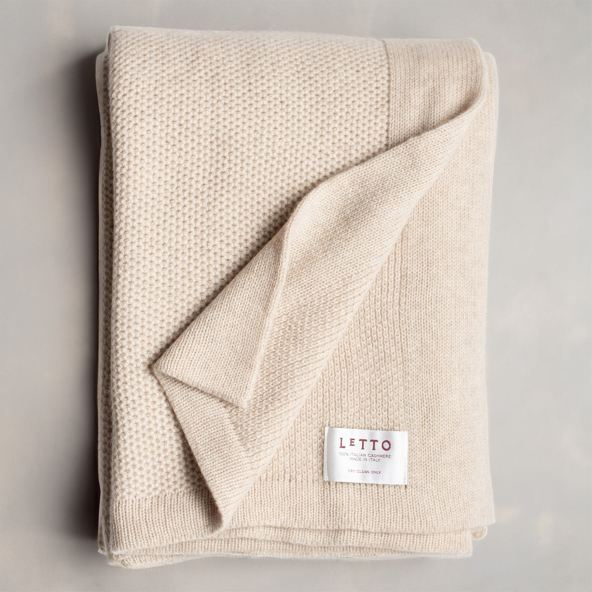 Image of the LETTO Domenica Knit Cashmere Throw in color Almond. data-image-id=