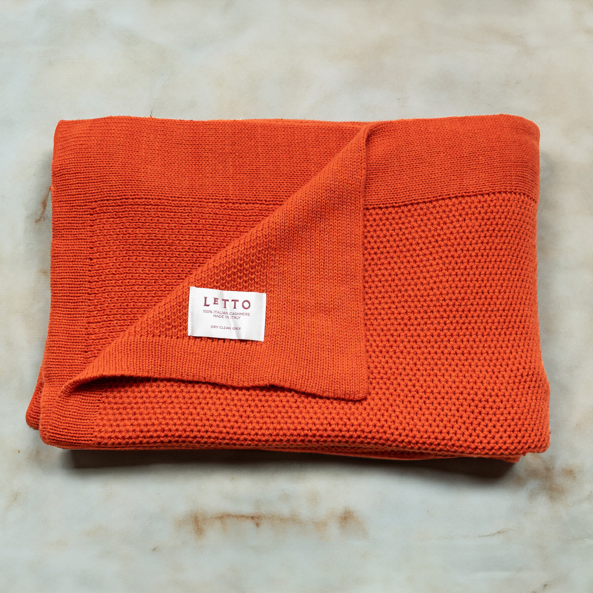 Image of the LETTO Domenica Knit Cashmere Throw in color Orange. data-image-id=