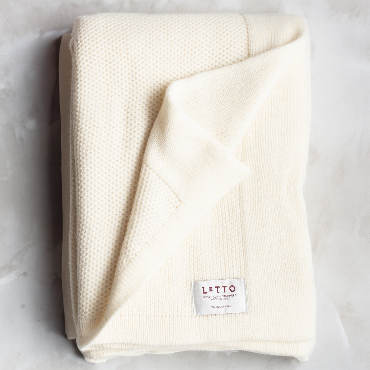 Image of the LETTO Domenica Knit Cashmere Throw in color Vanilla. data-image-id=