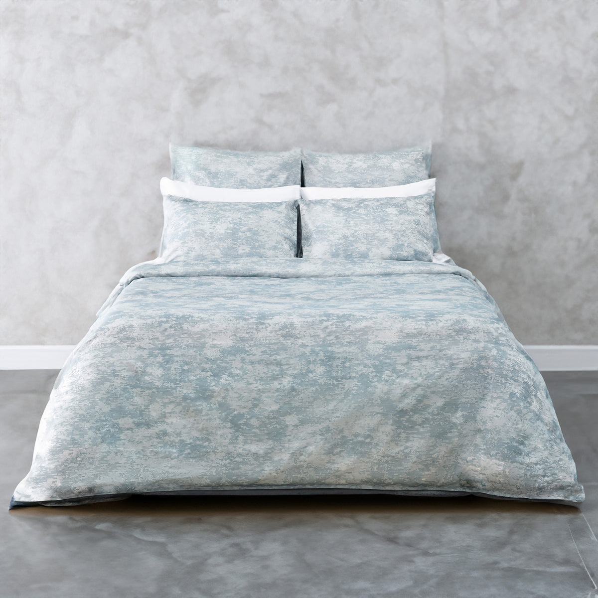 A bed made with the LETTO Le Marais Jacquard Duvet and Sham set in color Ocean. data-image-id=