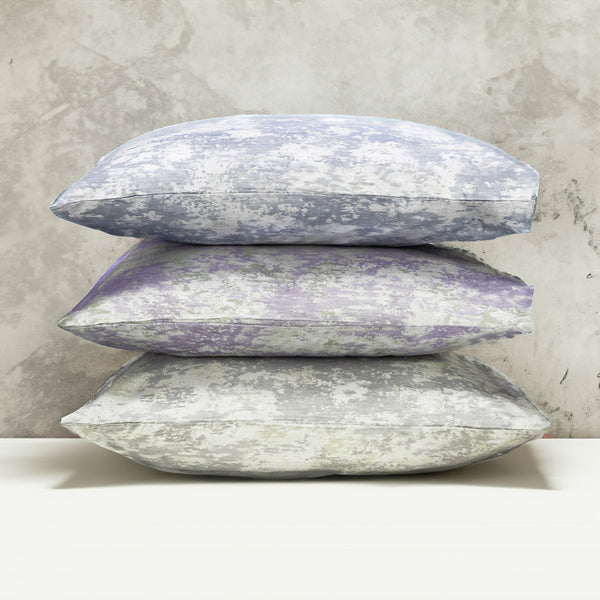 A stack of pillows in three colors of the with LETTO Le Marais Jacquard pattern.