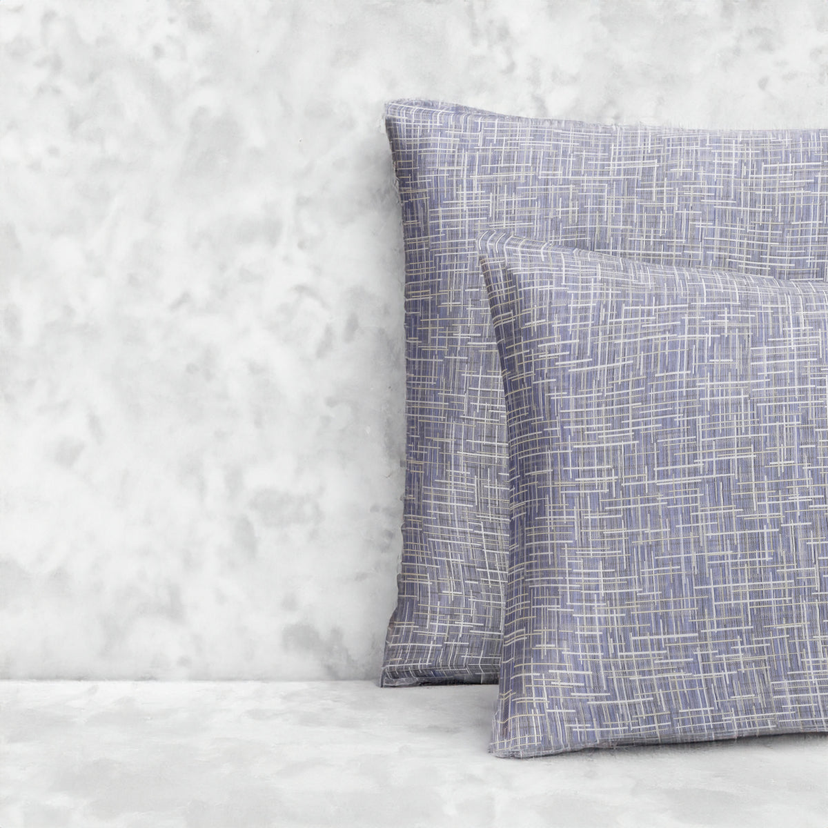 An image of two pillows stacked one in front of the other. The pillow cases are made of LETTO Mosaico Jacquard fabric in color Denim. data-image-id=