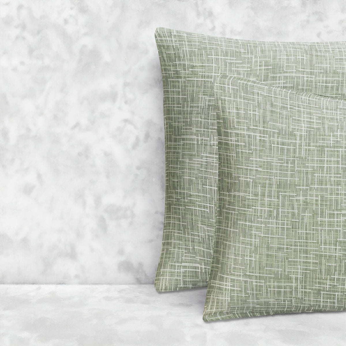 An image of two pillows stacked one in front of the other. The pillow cases are made of LETTO Mosaico Jacquard fabric in color Green. data-image-id=