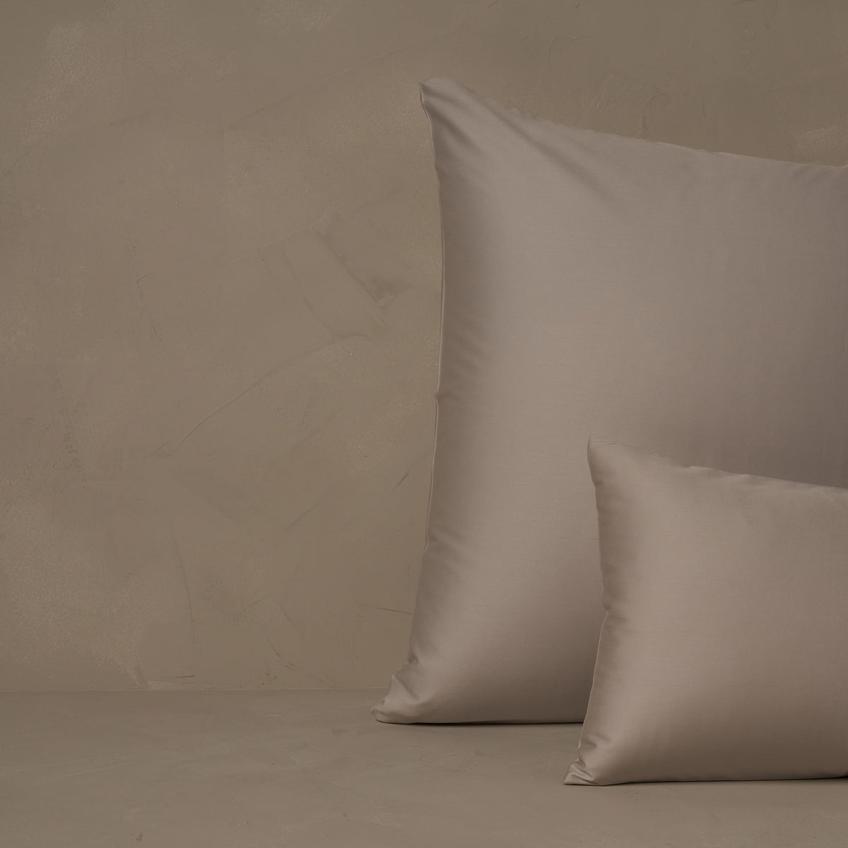 An image of a small boudoir or travel size pillow stacked in front of a large euro size pillow. The pillow cases are made of LETTO's warm and buttery Classic Cotton Sateen in color gray. data-image-id=