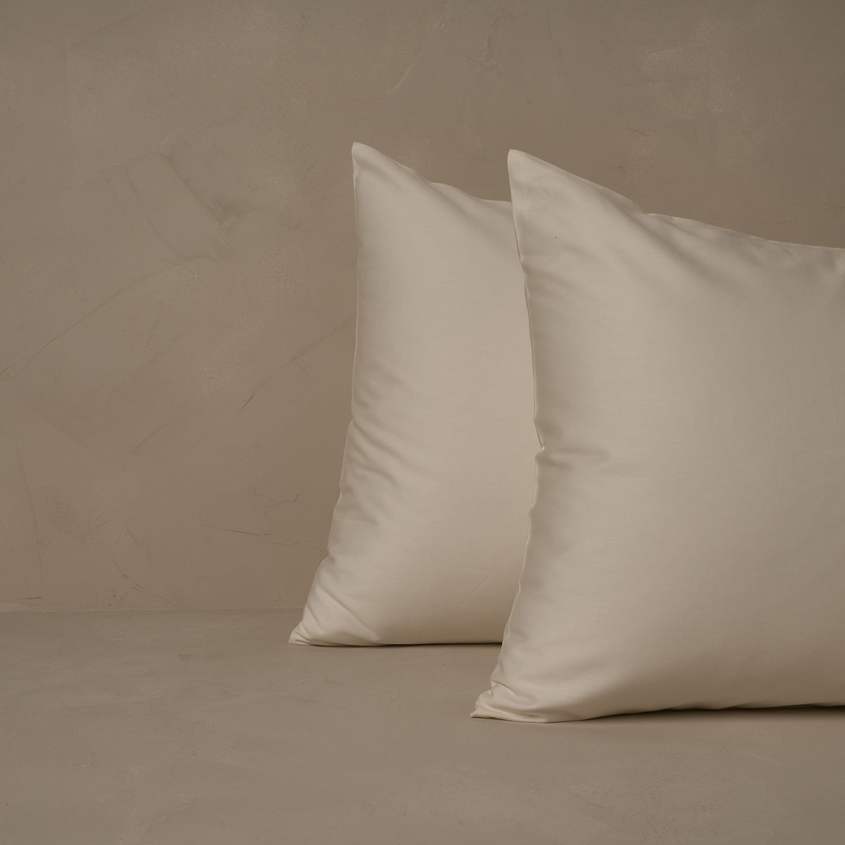 An image of two pillows stacked one in front of the other. The pillow cases are made of LETTO's warm and buttery Classic Cotton Sateen in color ivory. data-image-id=