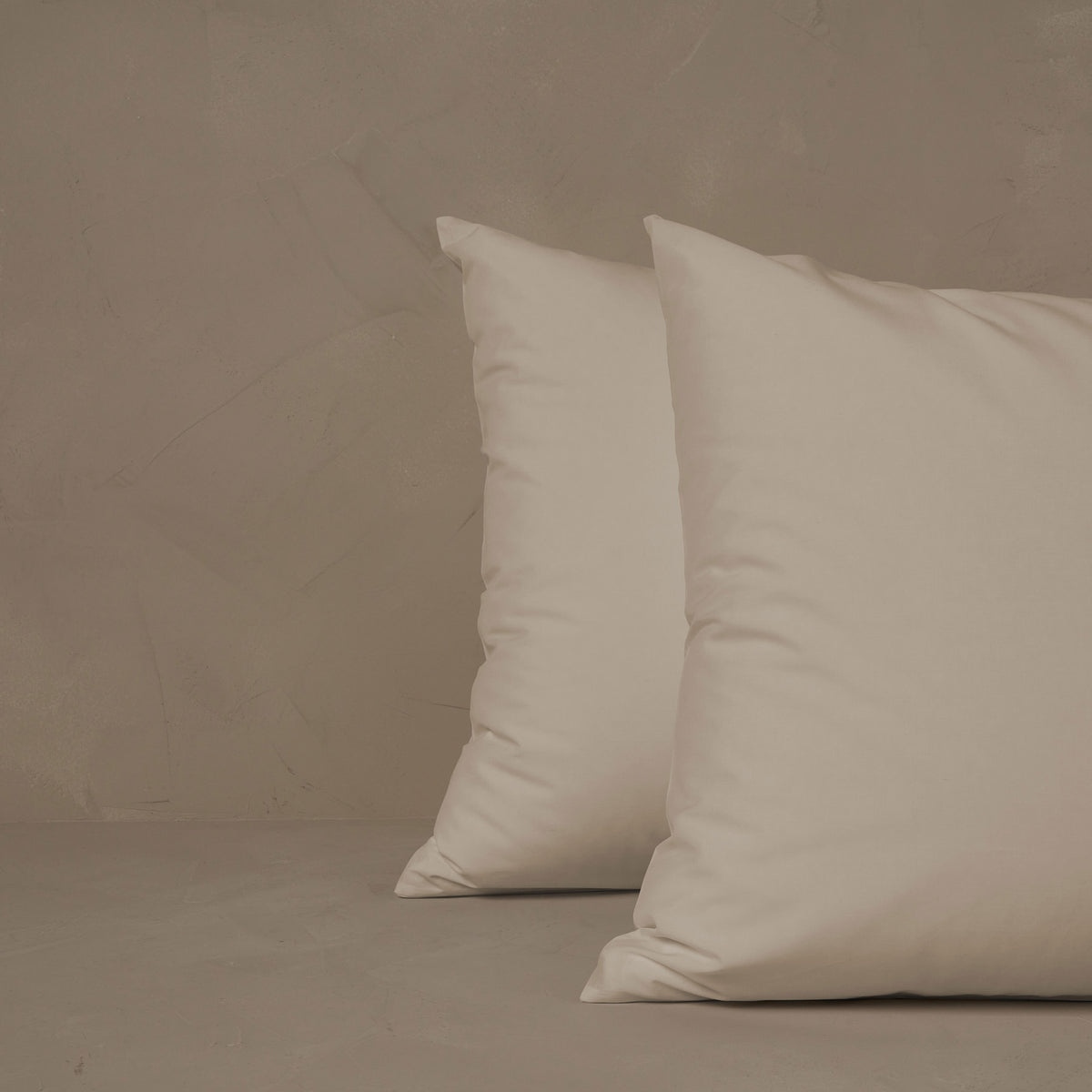 An image of two pillows stacked one in front of the other. The pillow cases are made of LETTO Giza Reserve Cotton Percale in color ivory. data-image-id=