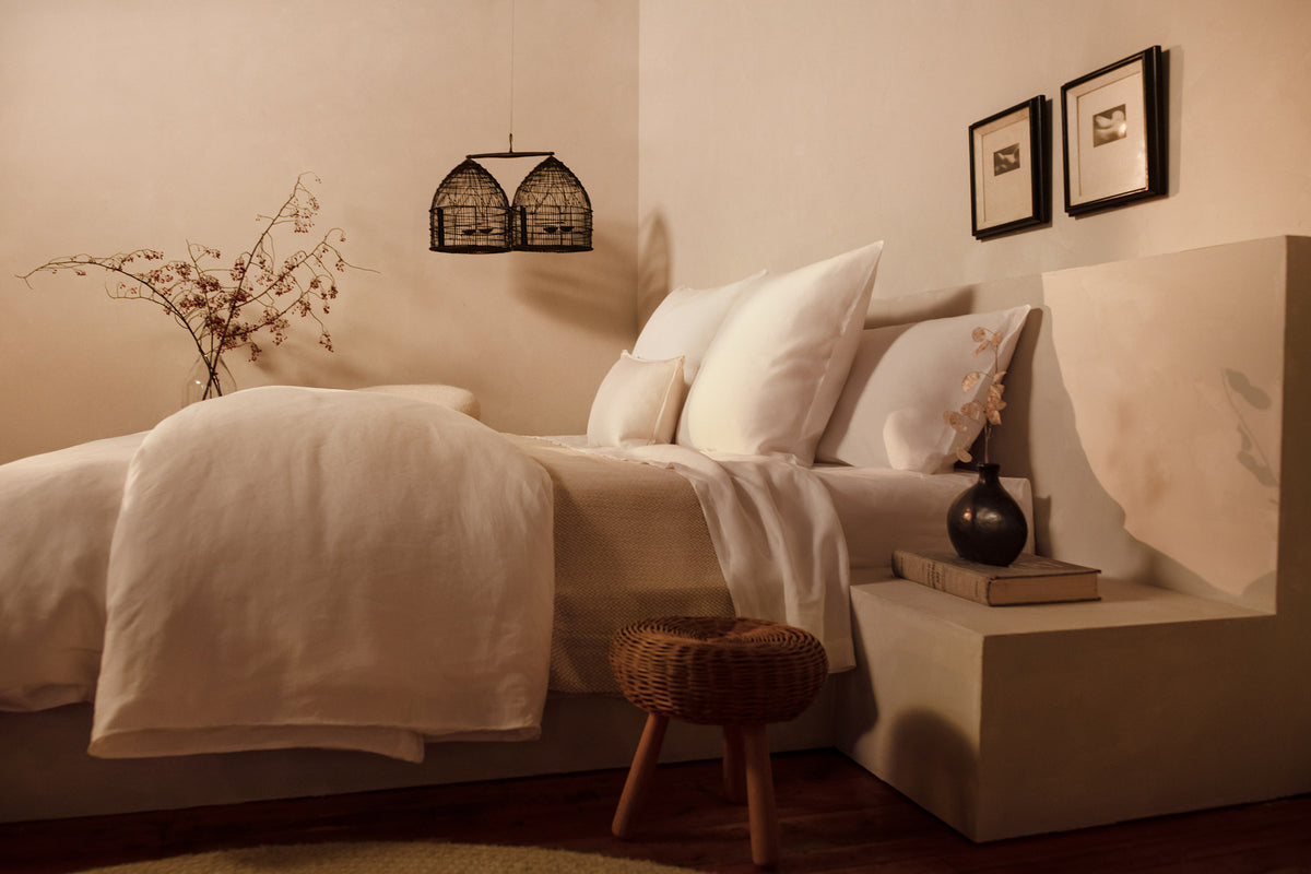 A image of an elegantly made bed in 100% linen with LETTO Lino Primo pillows and duvet cover.  data-image-id=