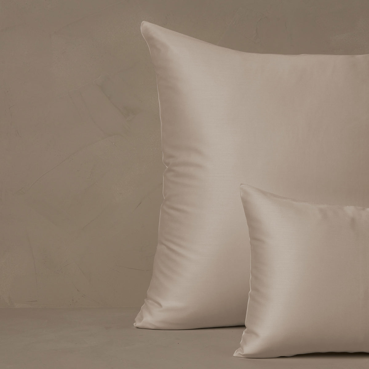 An image of a small boudoir or travel size pillow stacked in front of a large euro size pillow. The pillow cases are made in Italy of LETTO Woodland Silk fabric in color ivory, a smooth and silky beechwood modal. data-image-id=